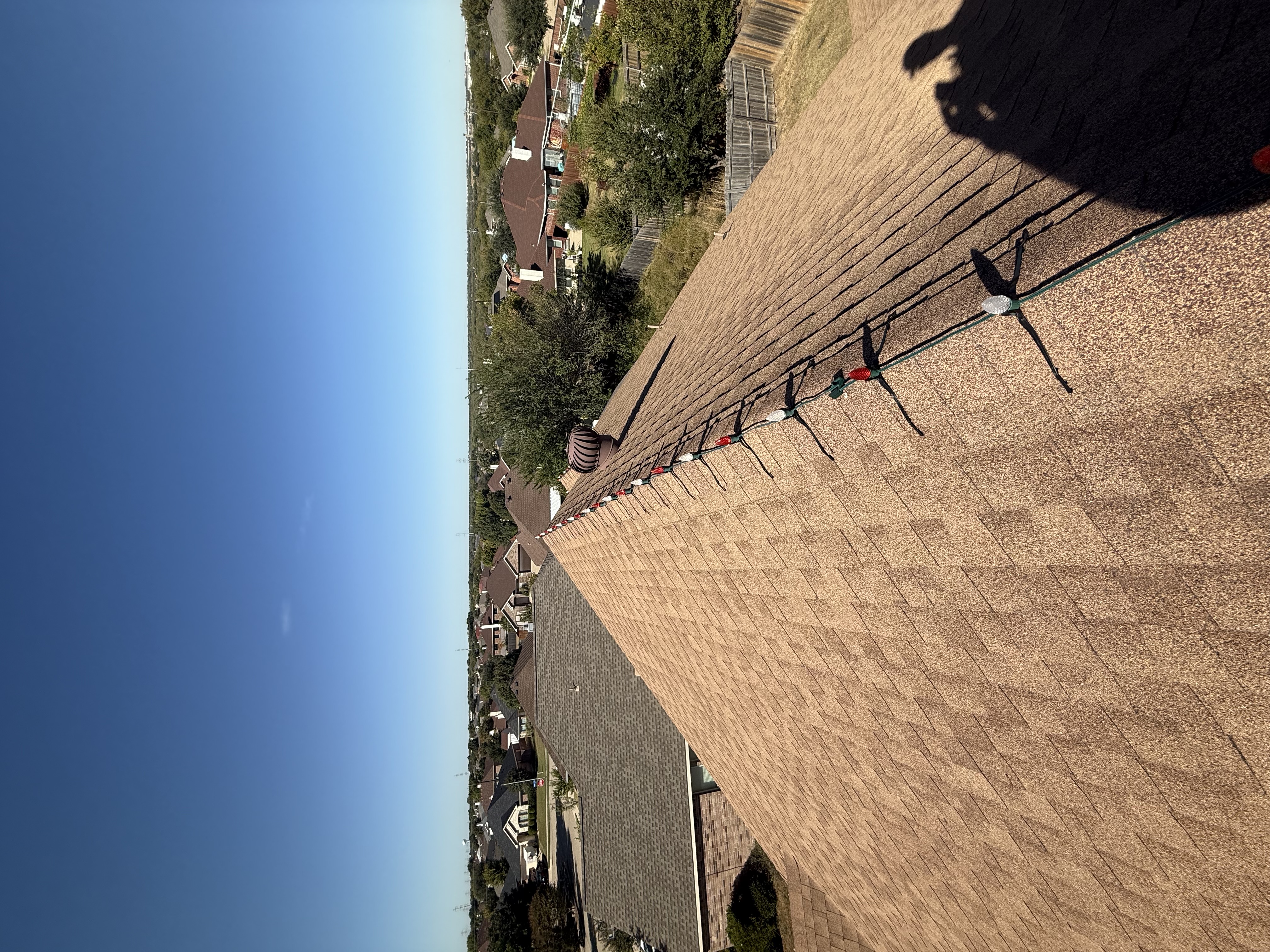 Permanent lighting tracks installed on residential roofline