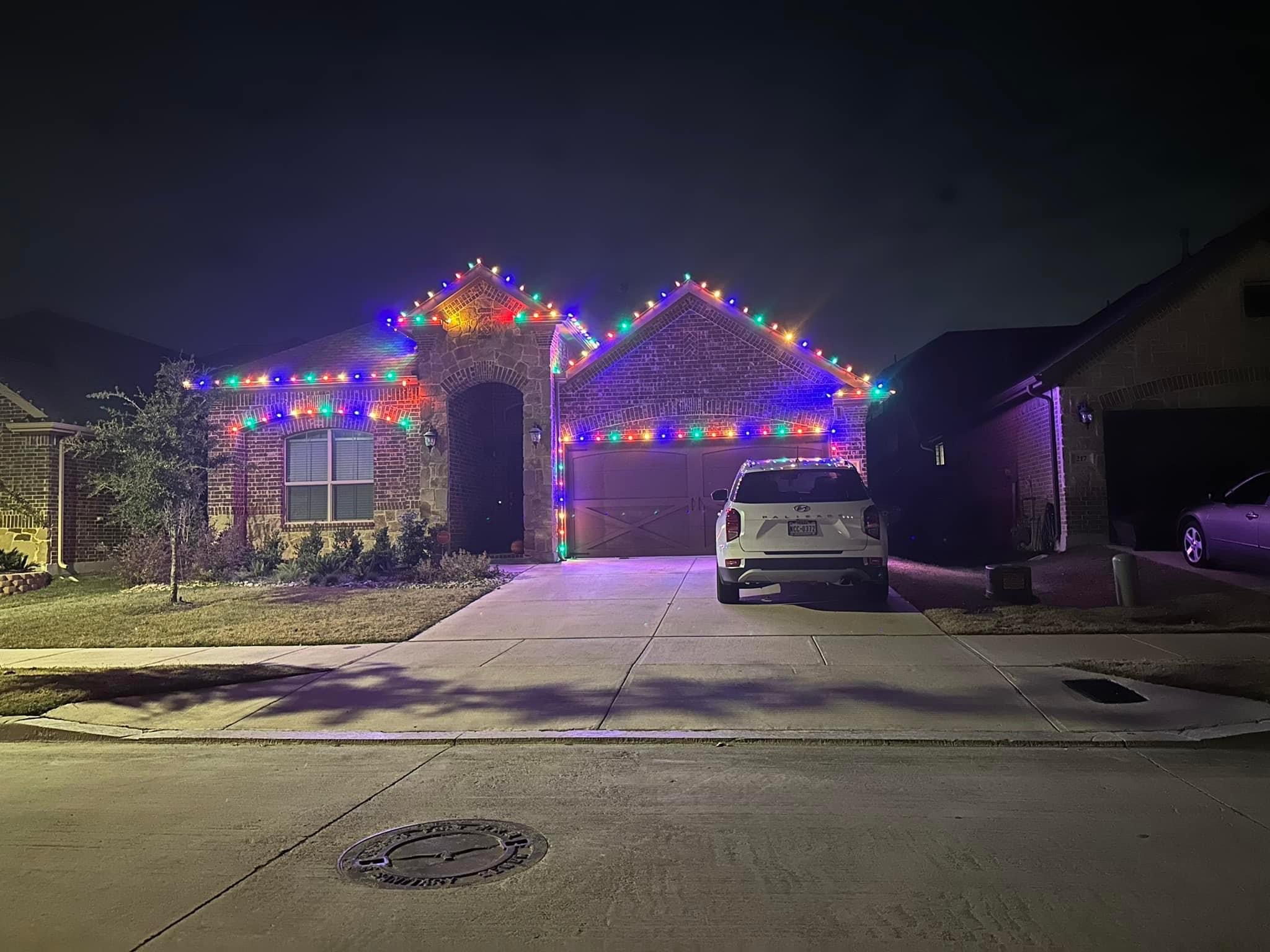 Beautiful multicolor C9 bulbs on two-story home roofline display