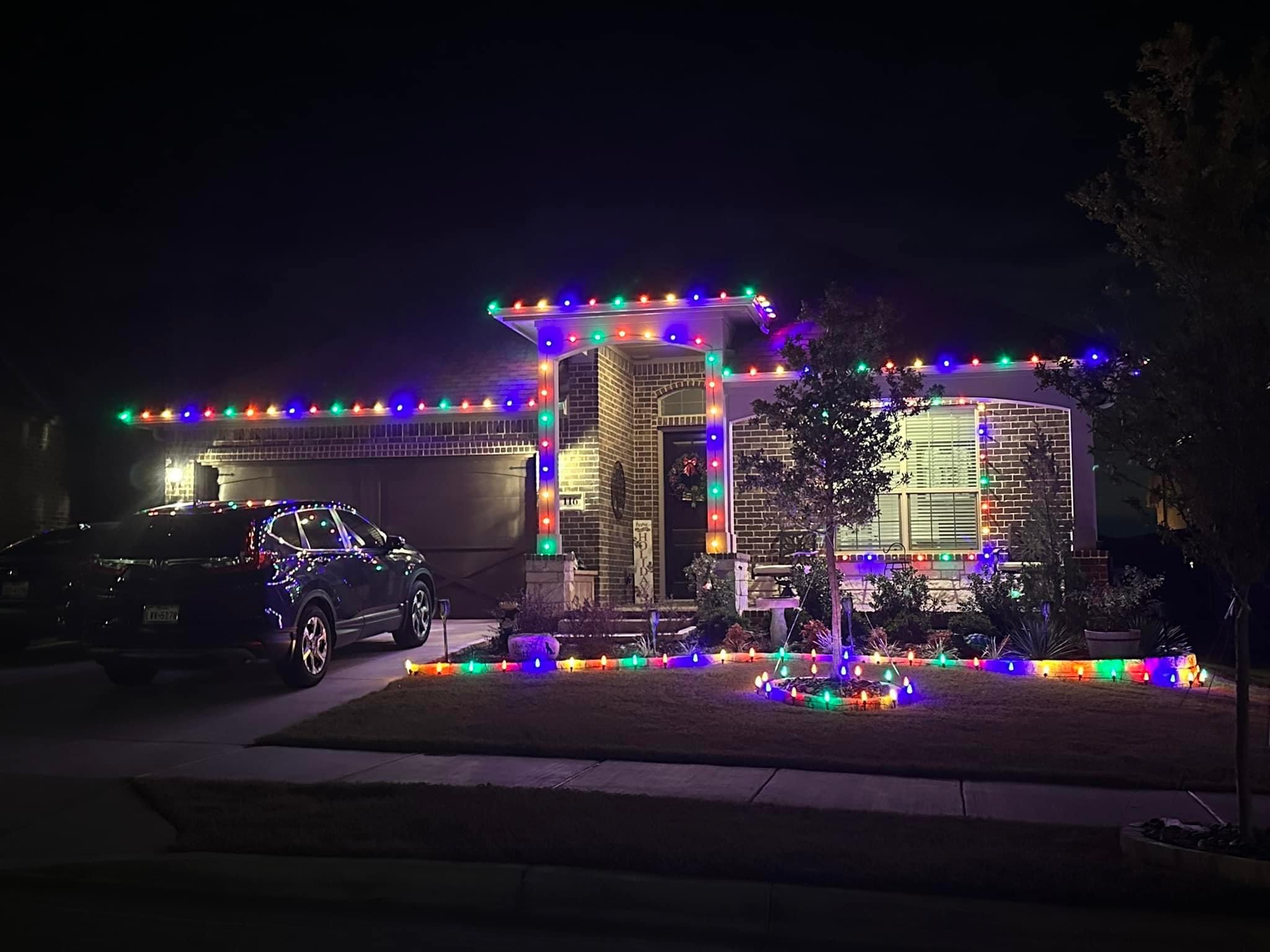 Vibrant multicolor holiday lights illuminating brick home at night