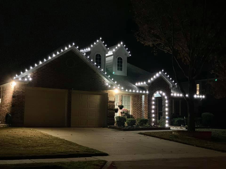 Elegant warm white lights professionally installed on home at night
